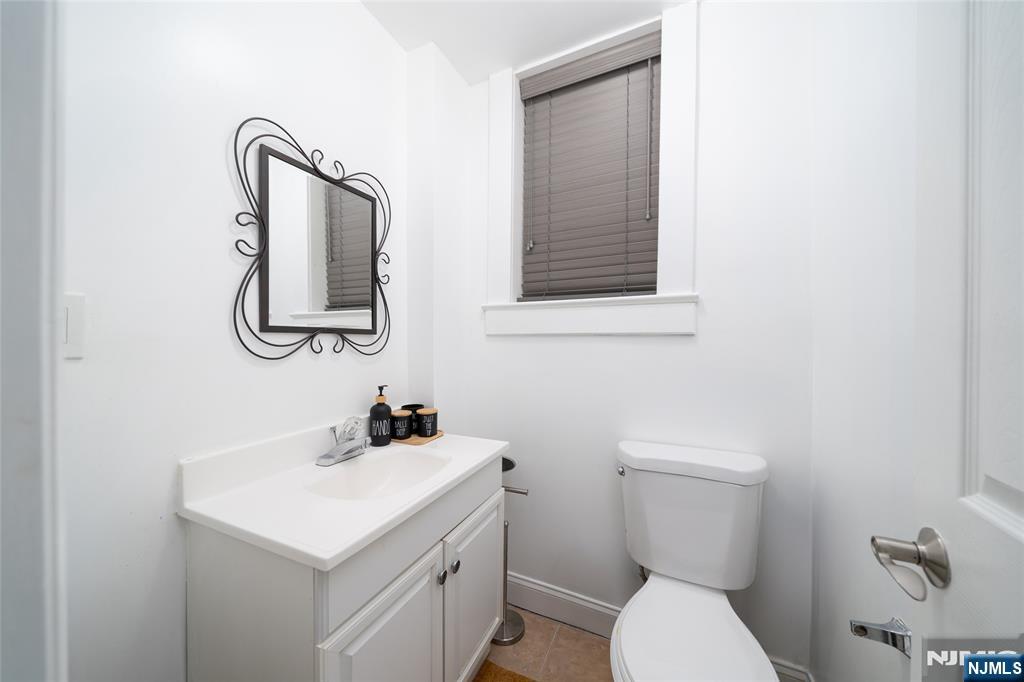 26 Orange Road Montclair, NJ 07042 - Photo 25 of 45 a bathroom with a toilet sink and mirror