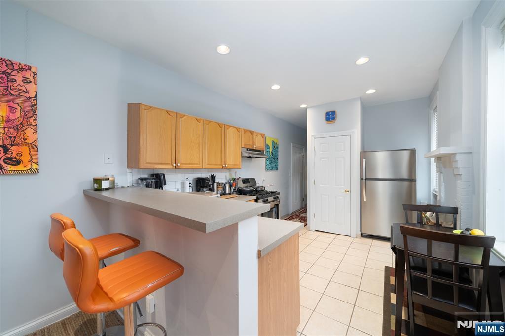 26 Orange Road Montclair, NJ 07042 - Photo 34 of 45 a kitchen with stainless steel appliances granite countertop a sink and a refrigerator
