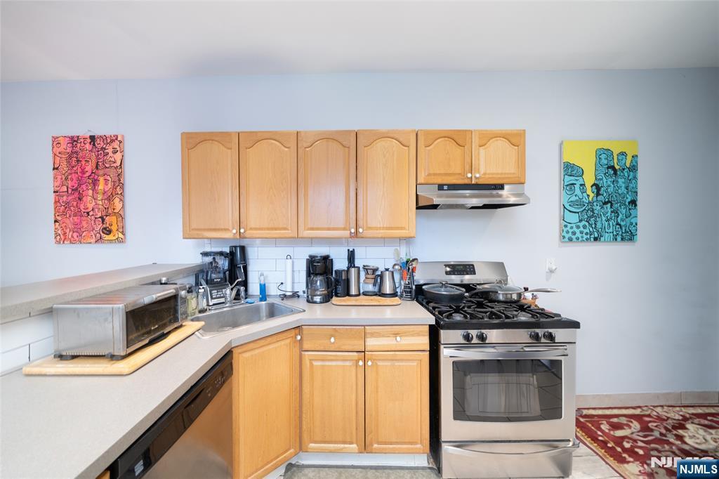26 Orange Road Montclair, NJ 07042 - Photo 35 of 45 a kitchen with stainless steel appliances a stove sink and cabinets