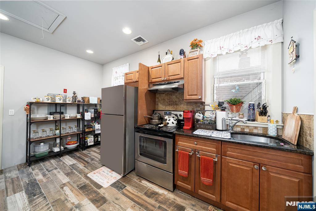 26 Orange Road Montclair, NJ 07042 - Photo 44 of 45 a kitchen with stainless steel appliances granite countertop a refrigerator and a stove