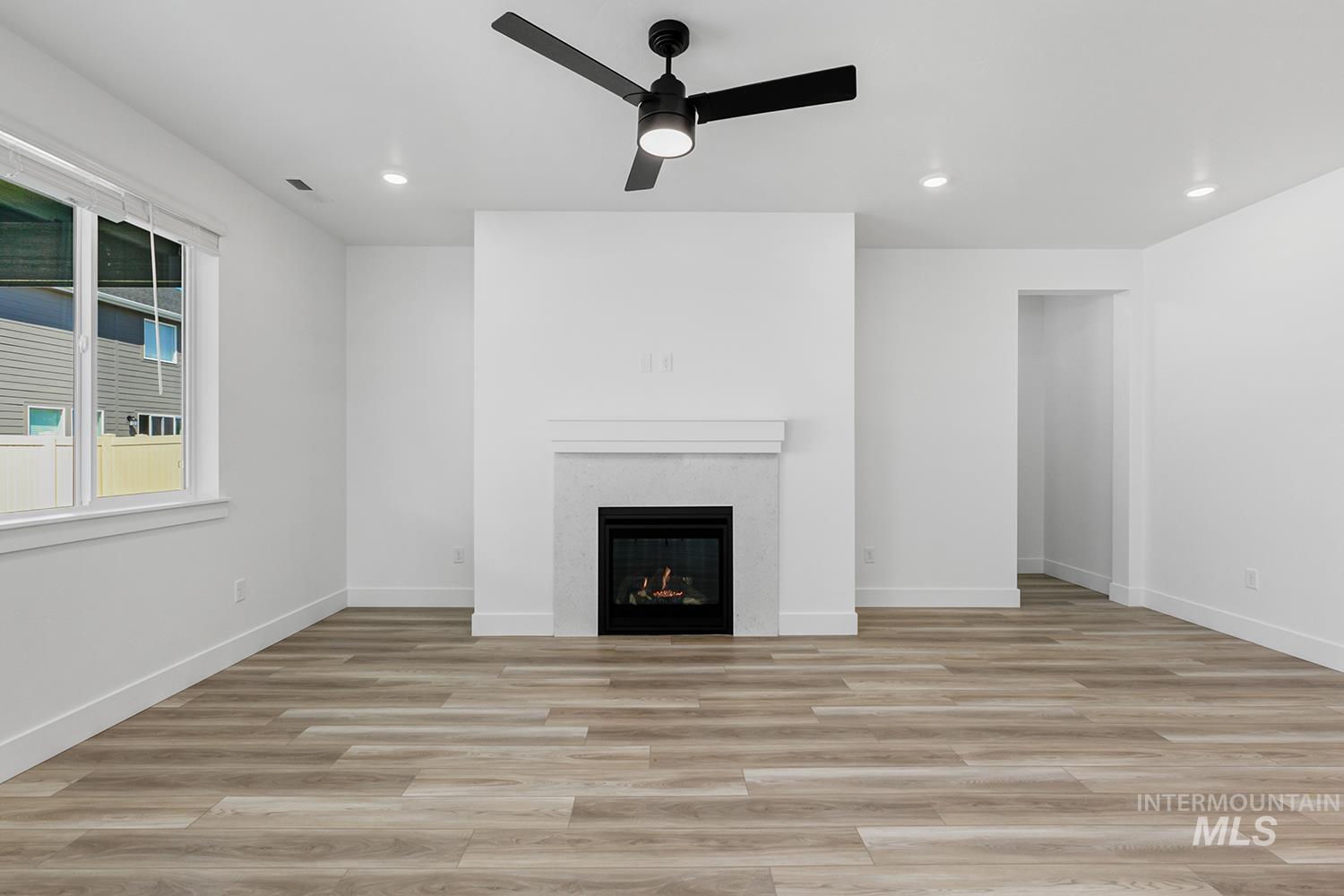 4548 West Wapoot Street Meridian, ID 83646 - Photo 5 of 17 Living area featuring an electric fireplace with a white mantel and mosaic tile surround