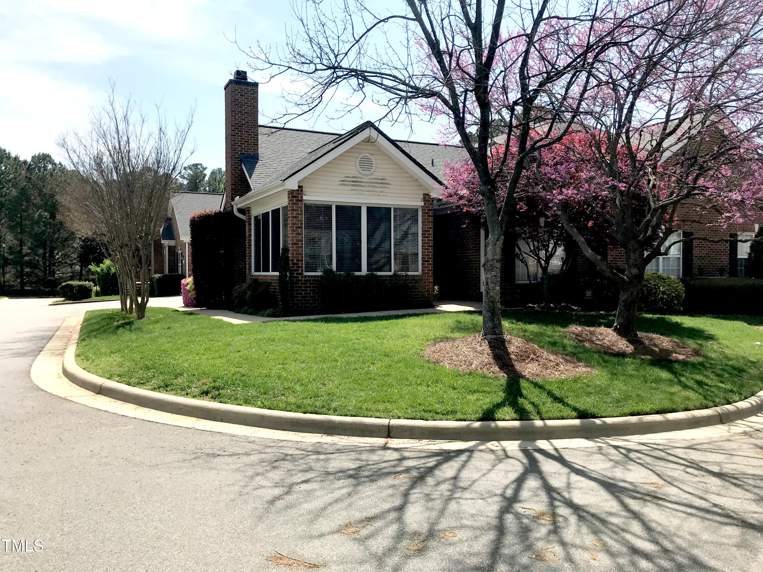 2002 Clyde Bank Court Cary, NC 27511 - Photo 1 of 58 a front view of a house with a garden and trees