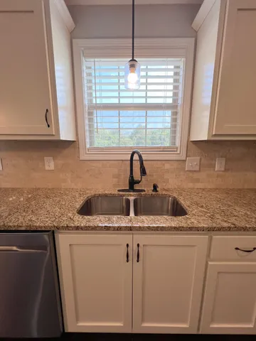 a kitchen with stainless steel appliances a refrigerator sink and cabinets