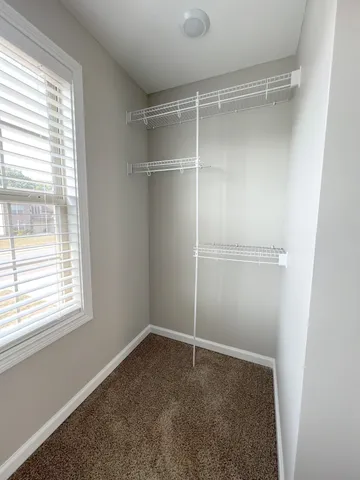 a spacious bathroom with a granite countertop sink and a mirror