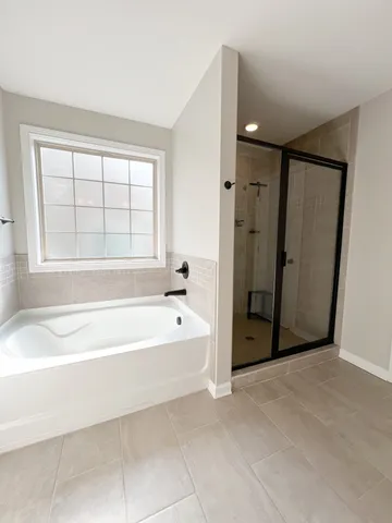 a white toilet sitting next to a shower