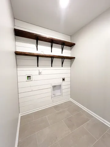 a view of a hallway with wooden shelves