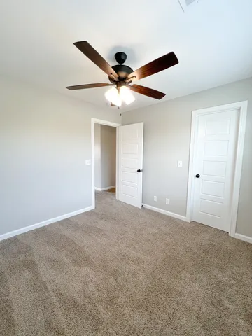 a bathroom with a granite countertop sink toilet a mirror and bathtub