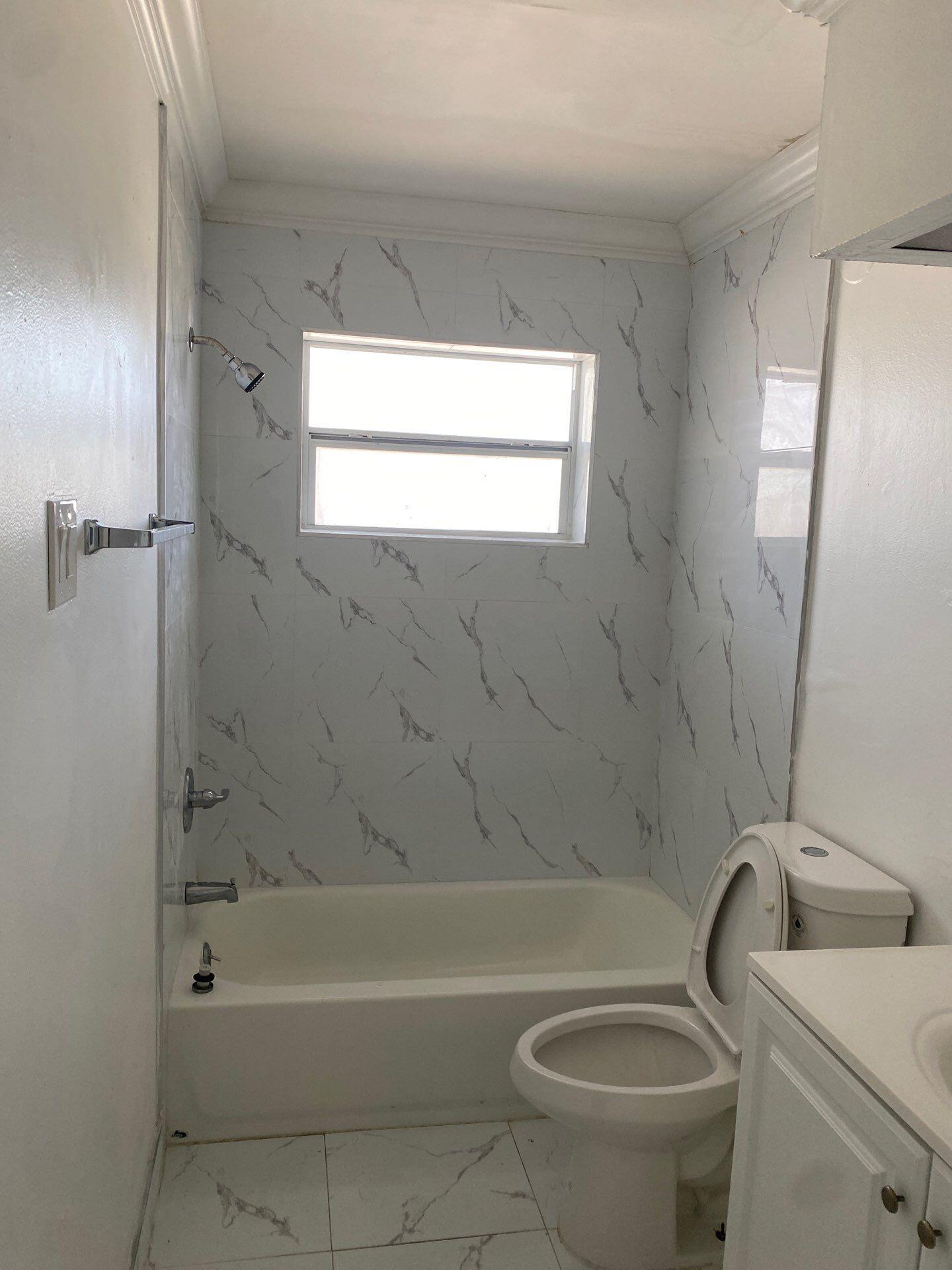 1450 East Sample Road, Unit 211 Pompano Beach, FL 33064 - Photo 3 of 4 a bath room with a toilet and a bath tub
