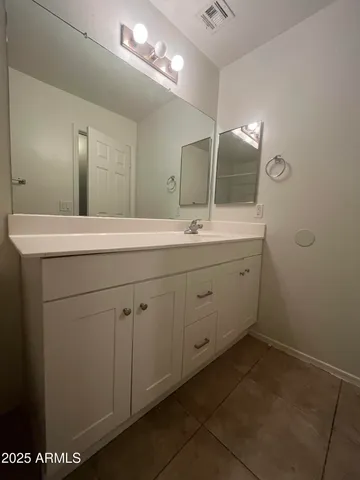 a bathroom with a sink a vanity and a mirror