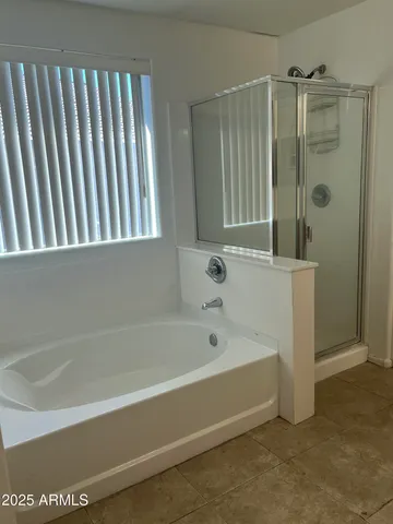 a bathroom with a bathtub and shower