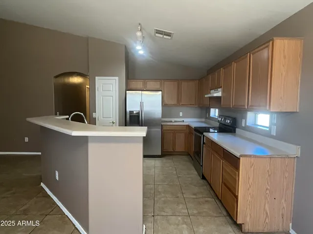 a kitchen with a sink a counter top space and cabinets