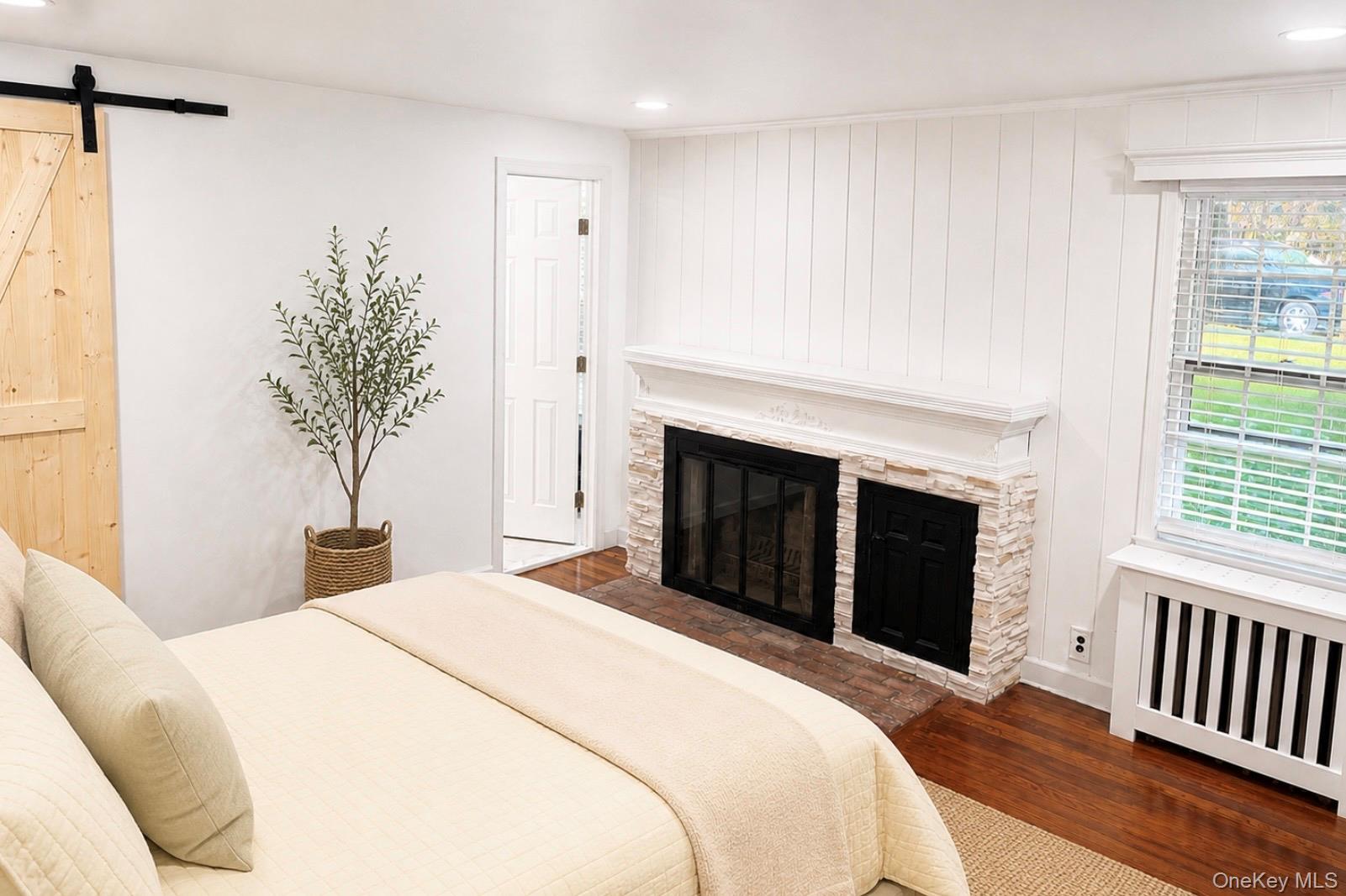 80 Mt Pleasant Road Smithtown, NY 11787 - Photo 11 of 27 a bedroom with a bed and a fireplace