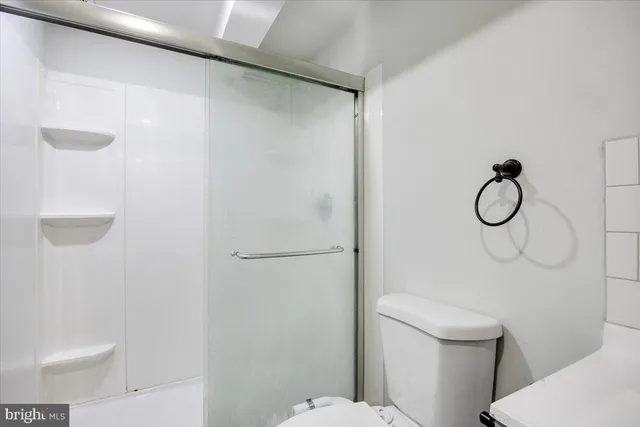 a white toilet sitting next to a bathroom sink