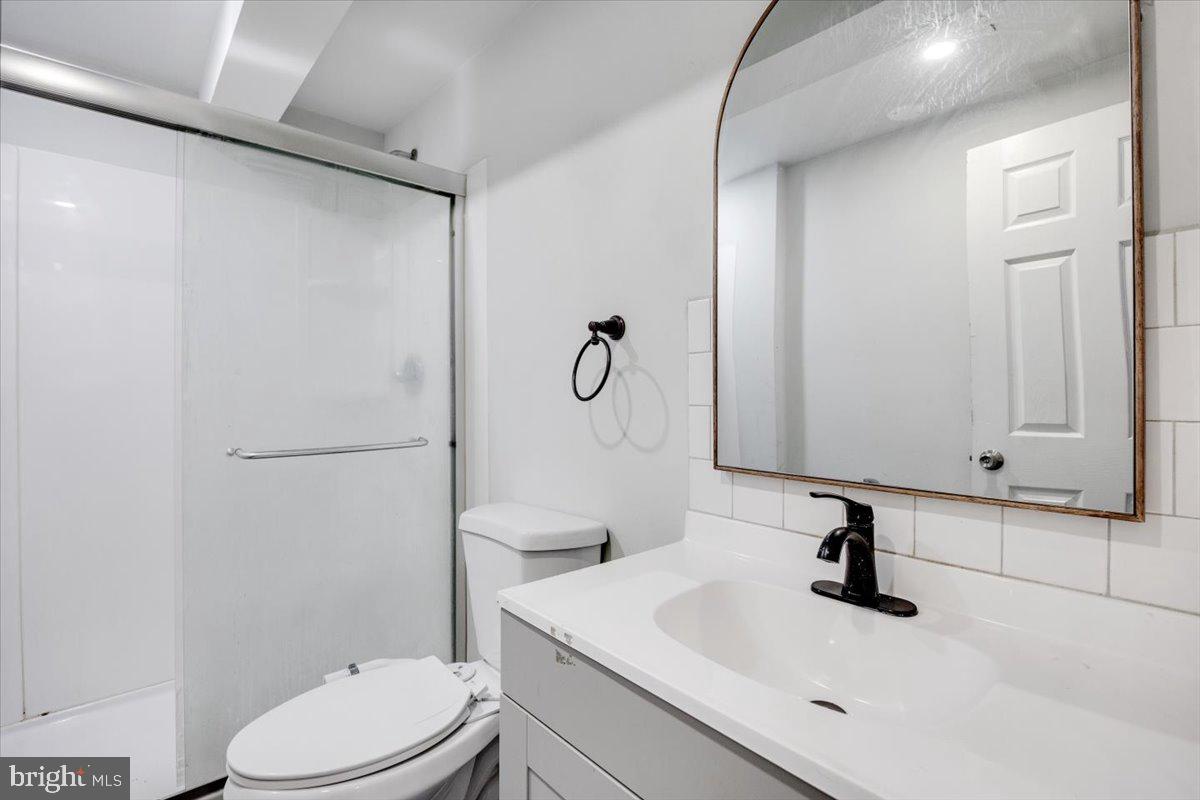 301 Broad Street Beverly, NJ 08010 - Photo 13 of 29 a bathroom with a sink a toilet and shower