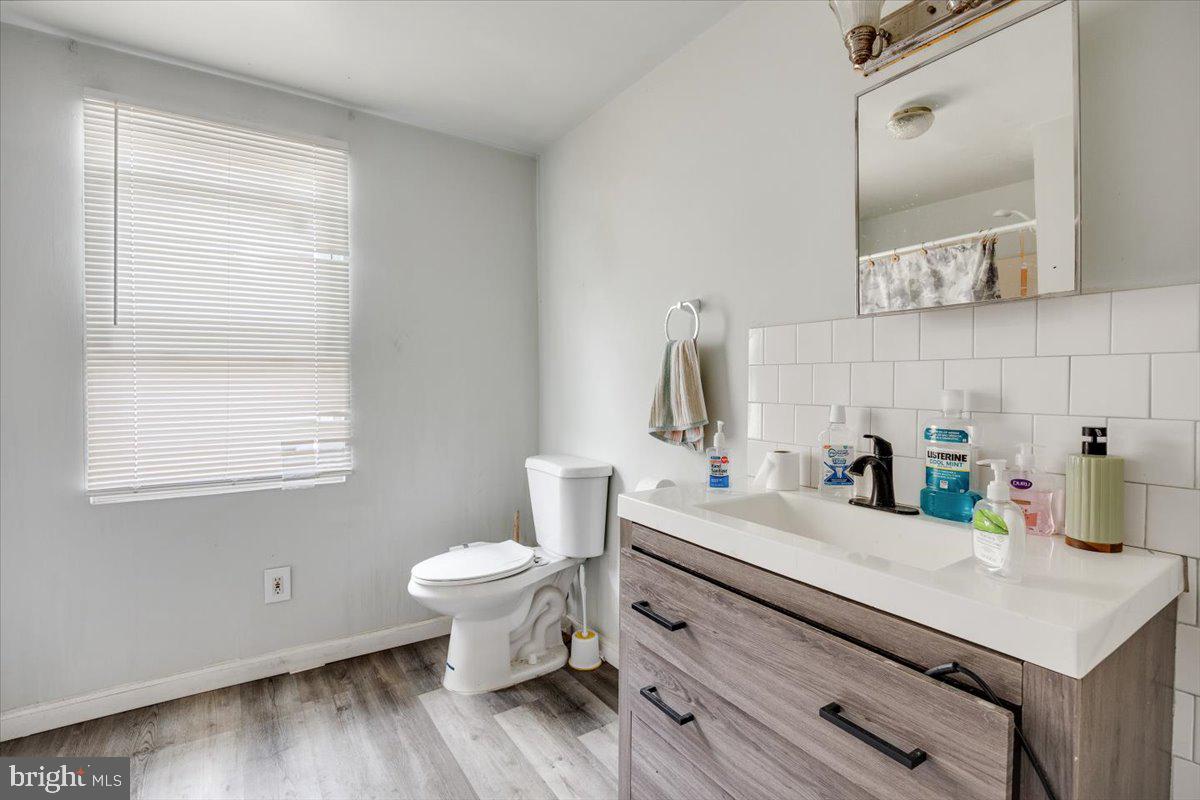 301 Broad Street Beverly, NJ 08010 - Photo 15 of 29 a bathroom with a sink toilet and mirror