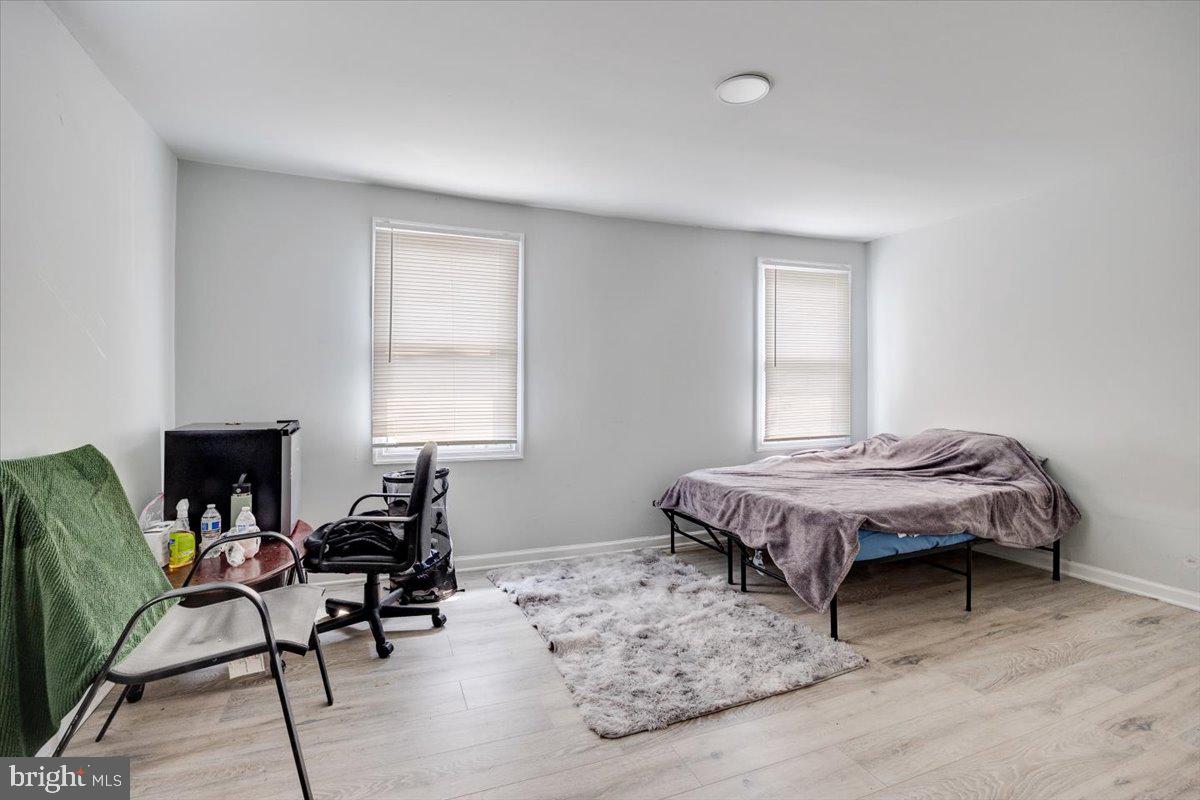 301 Broad Street Beverly, NJ 08010 - Photo 17 of 29 a bedroom with a bed table chair and a window