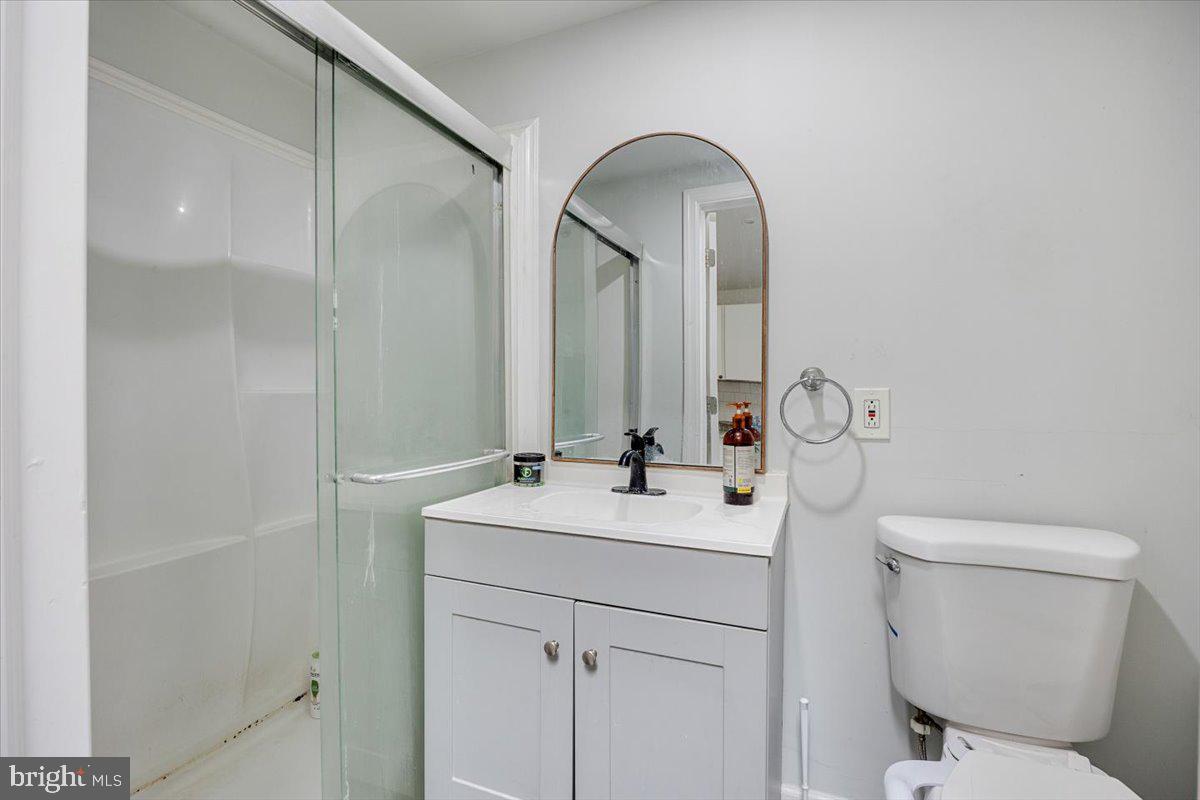 301 Broad Street Beverly, NJ 08010 - Photo 18 of 29 a bathroom with a toilet sink and mirror