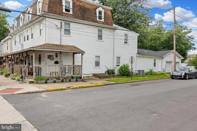 a front view of a house with a yard and a garage