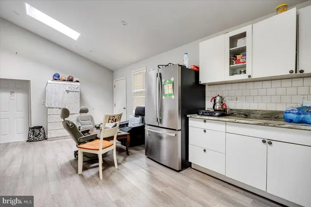 a kitchen with stainless steel appliances granite countertop a refrigerator and microwave