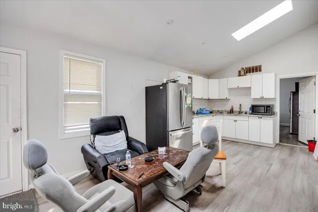 a living room with furniture and kitchen view