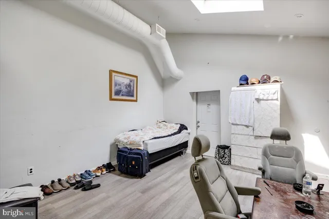 a bedroom with furniture and a wooden floor