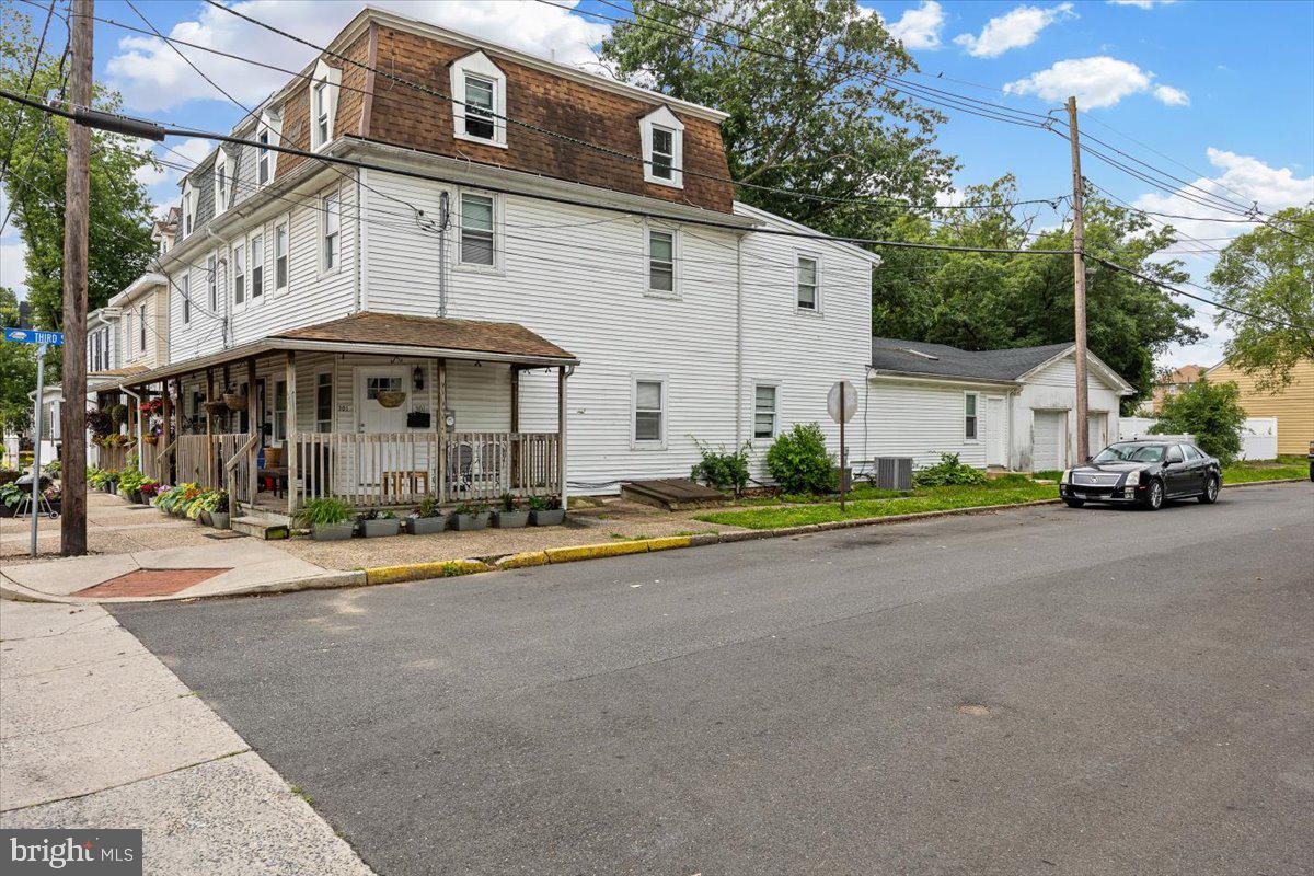 301 Broad Street Beverly, NJ 08010 - Photo 3 of 29 a front view of a building with small garden and plants