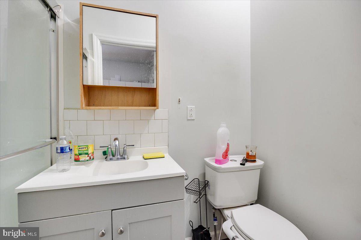 301 Broad Street Beverly, NJ 08010 - Photo 5 of 29 a bathroom with a sink mirror and toilet