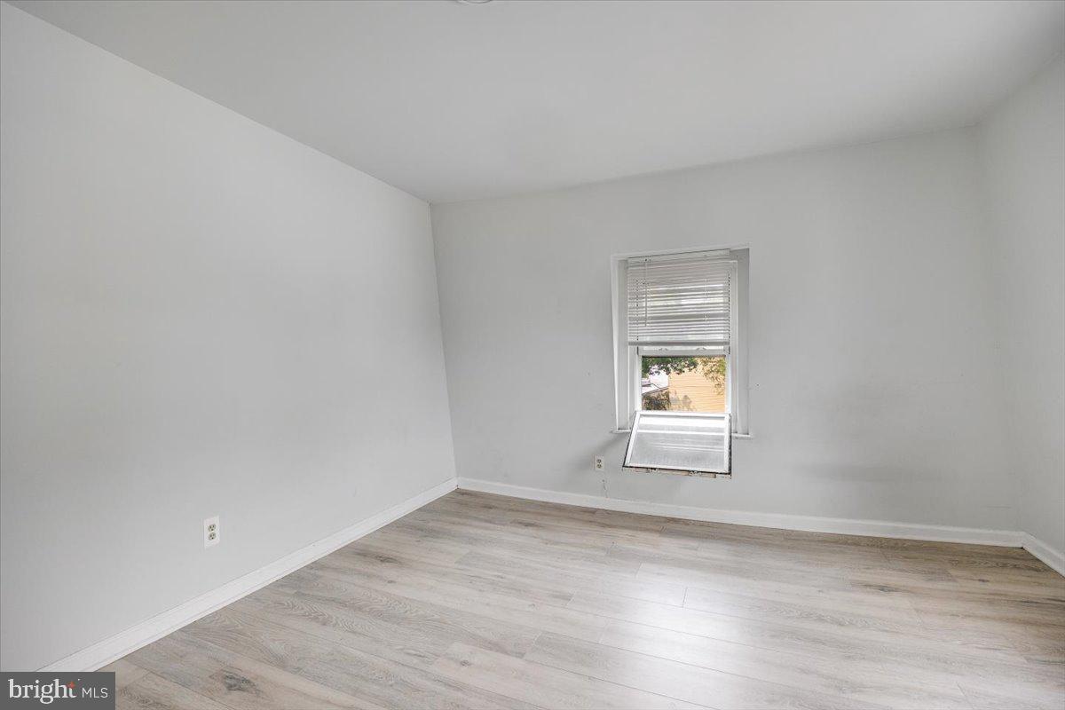 301 Broad Street Beverly, NJ 08010 - Photo 10 of 29 a view of an empty room with wooden floor and a window