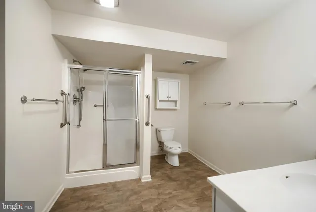 a view of storage and utility room with refrigerator and washer