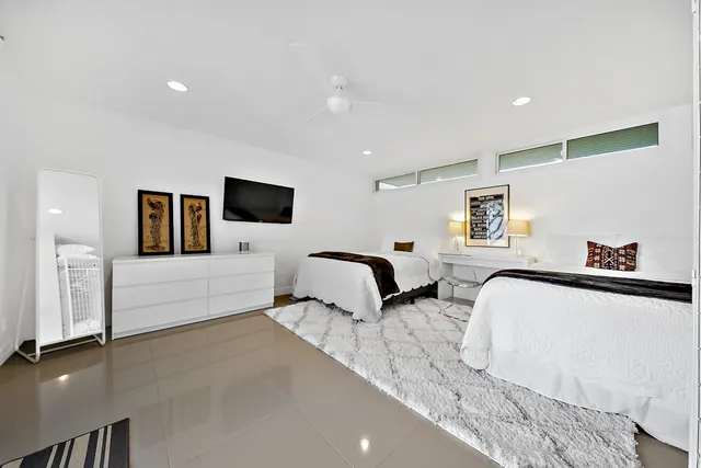 a spacious bedroom with a bed and a couch