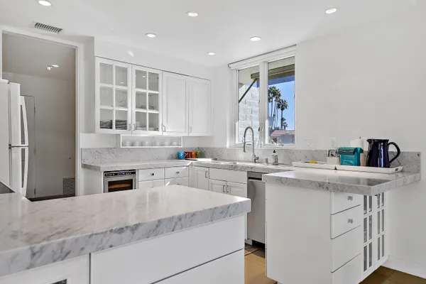 a kitchen with a sink stove and refrigerator
