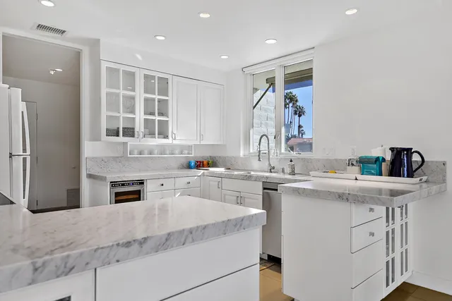 a kitchen with a sink stove and refrigerator