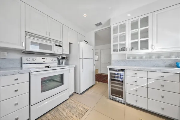 a kitchen with cabinets stainless steel appliances and counter space