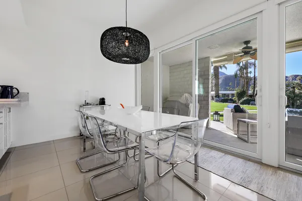a view of a dining room and chandelier fan wooden floor and a chandelier