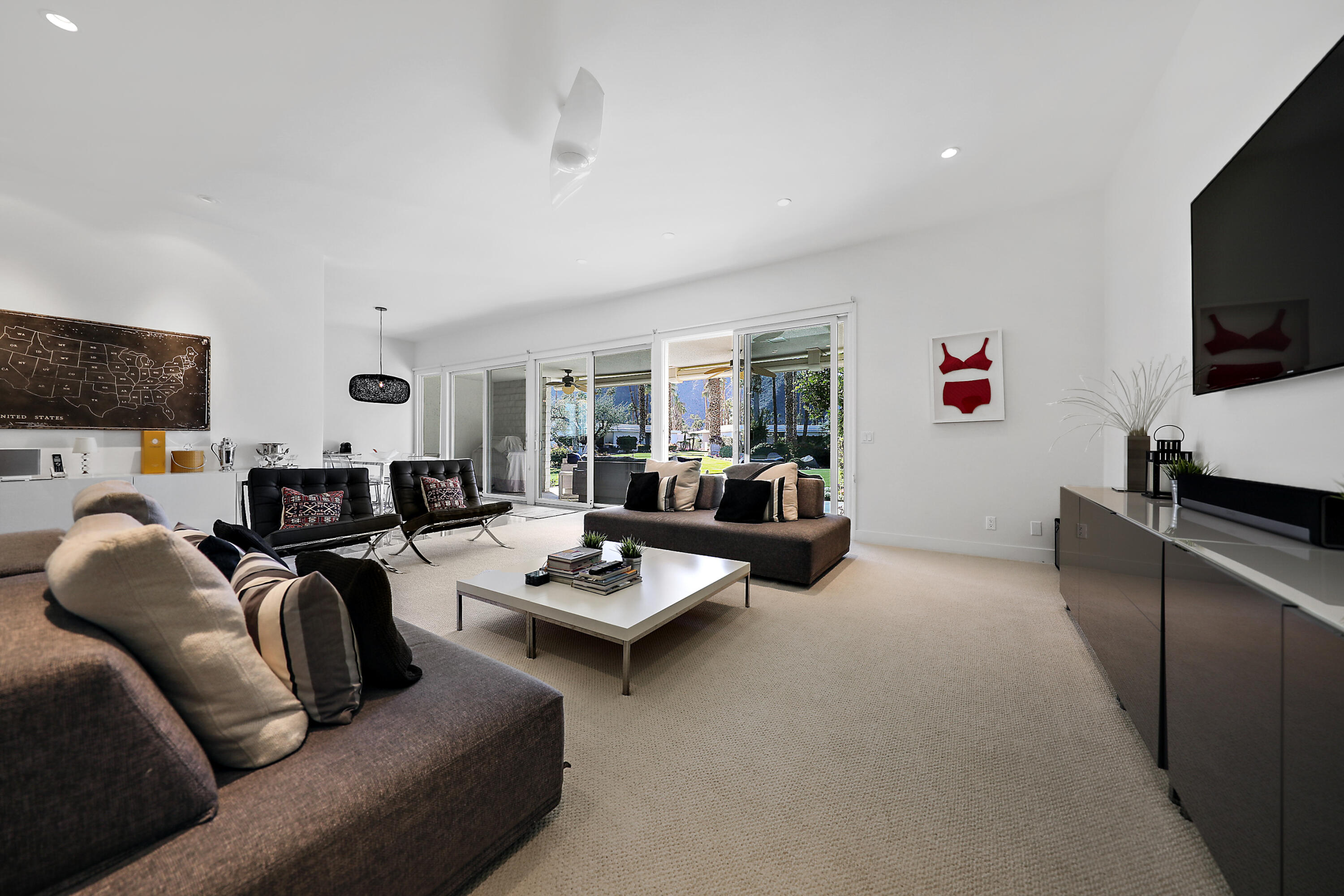 45705 Hopi Road Indian Wells, CA 92210 - Photo 10 of 25 a living room with furniture kitchen view and a flat screen tv