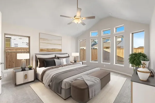 a bedroom with a large bed and a chandelier