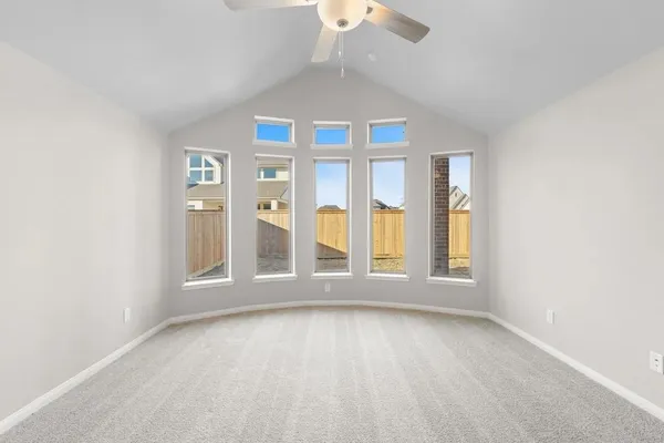 an empty room with windows and chandelier