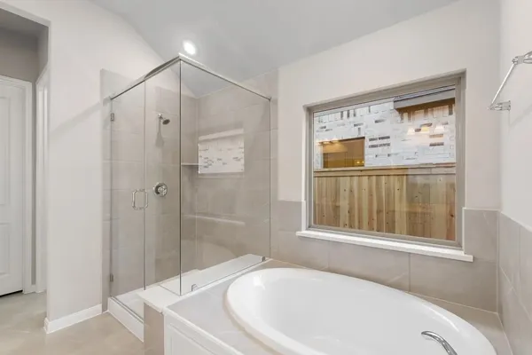 a bathroom with a bathtub and a shower