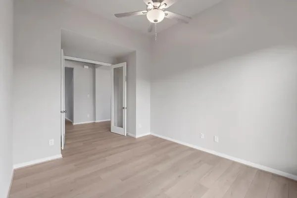 a view of an empty room with wooden floor