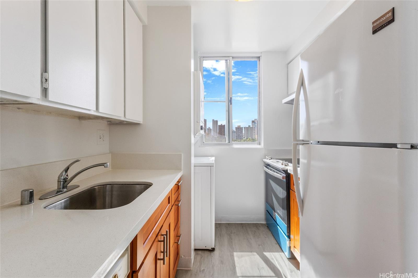 2916 Date Street, Unit 6G Honolulu, HI 96816 - Photo 4 of 20 a kitchen with stainless steel appliances a sink a refrigerator and cabinets