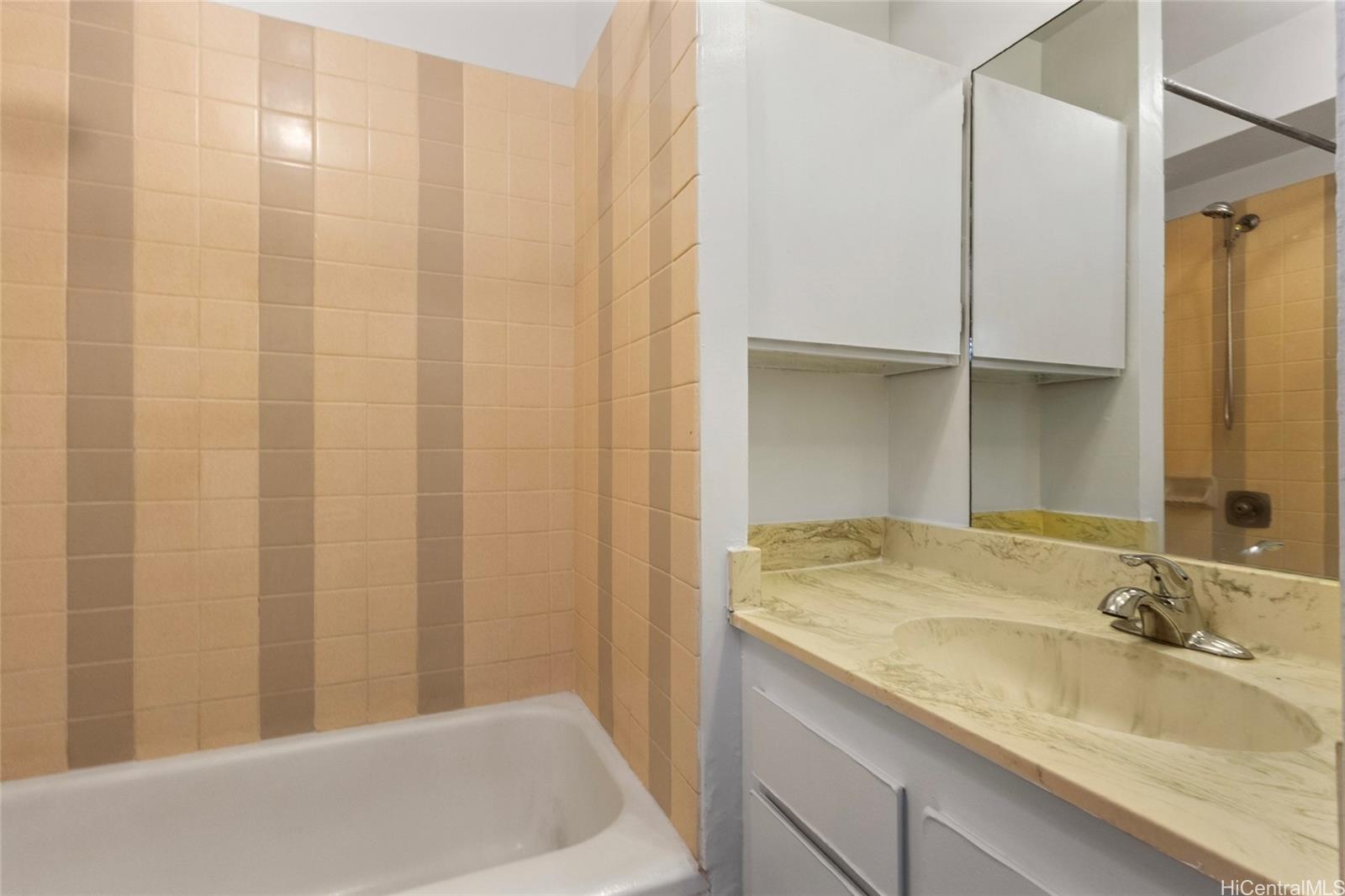 2916 Date Street, Unit 6G Honolulu, HI 96816 - Photo 10 of 20 a bathroom with a granite countertop sink and a mirror