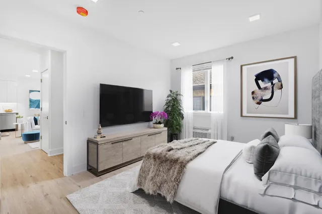 a bedroom with a bed and a flat screen tv