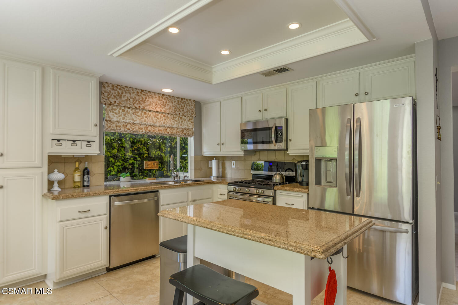 657 Galloping Hill Road Simi Valley, CA 93065 - Photo 11 of 34 a kitchen with stainless steel appliances granite countertop a refrigerator sink stove microwave and cabinets