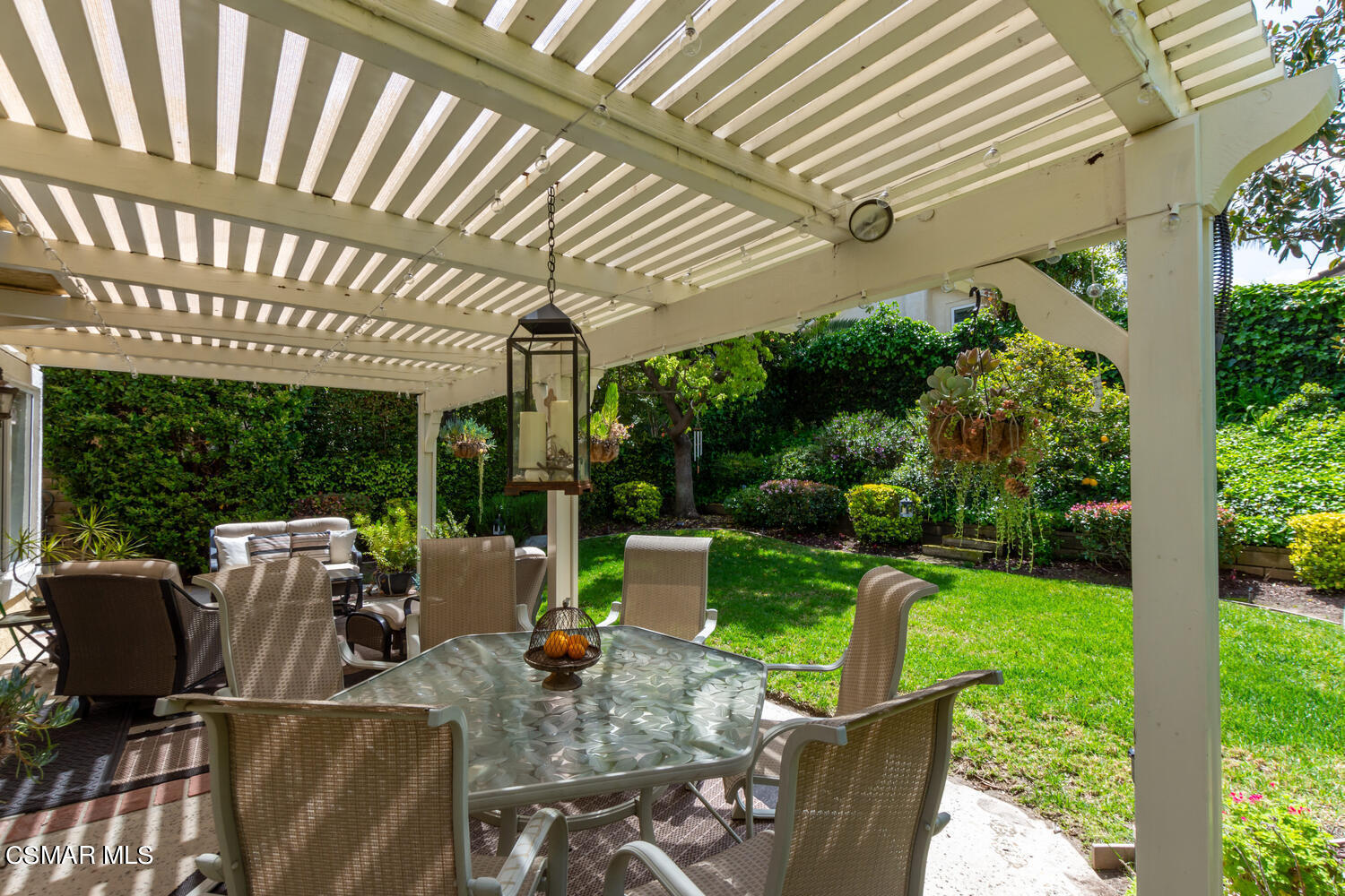 657 Galloping Hill Road Simi Valley, CA 93065 - Photo 24 of 34 a view of a patio with couches chairs potted plants and floor to ceiling window