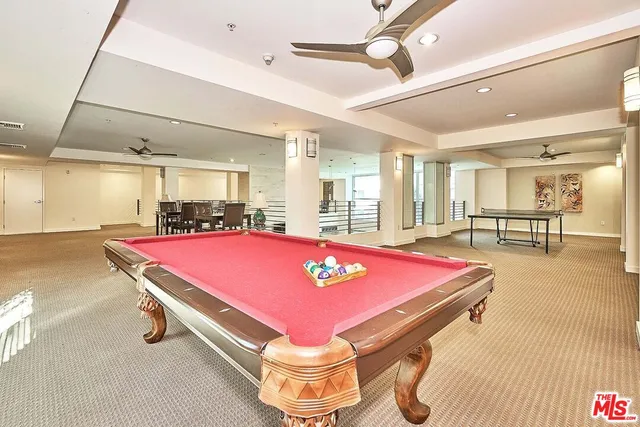 a room with pool table and windows