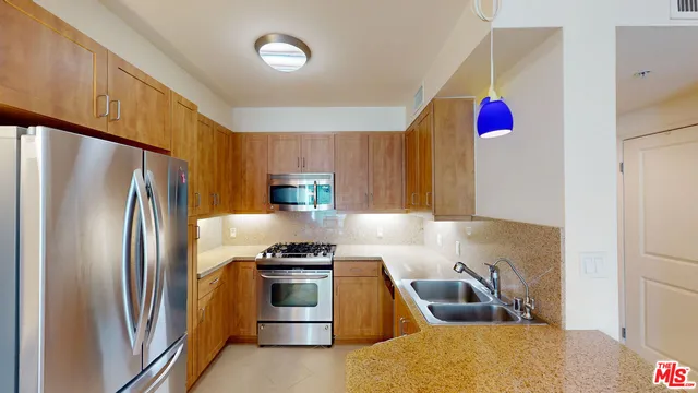 a kitchen with stainless steel appliances a refrigerator sink and cabinets