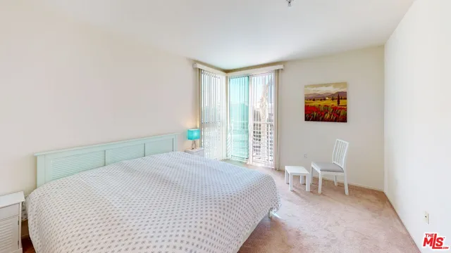 a bedroom with a bed and a chair