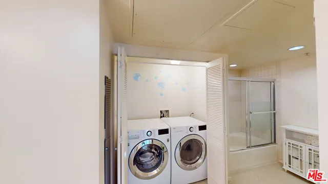 a view of storage and utility room with washer and dryer