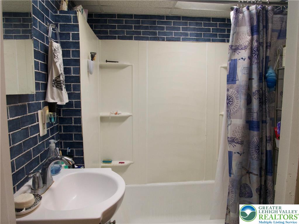 86 Garibaldi Avenue Roseto, PA 18013 - Photo 25 of 30 a bathroom with a sink and shower