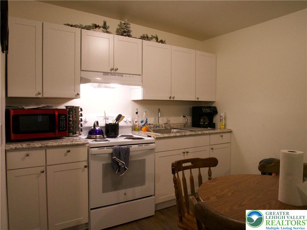 86 Garibaldi Avenue Roseto, PA 18013 - Photo 8 of 30 a kitchen with white cabinets sink and stove